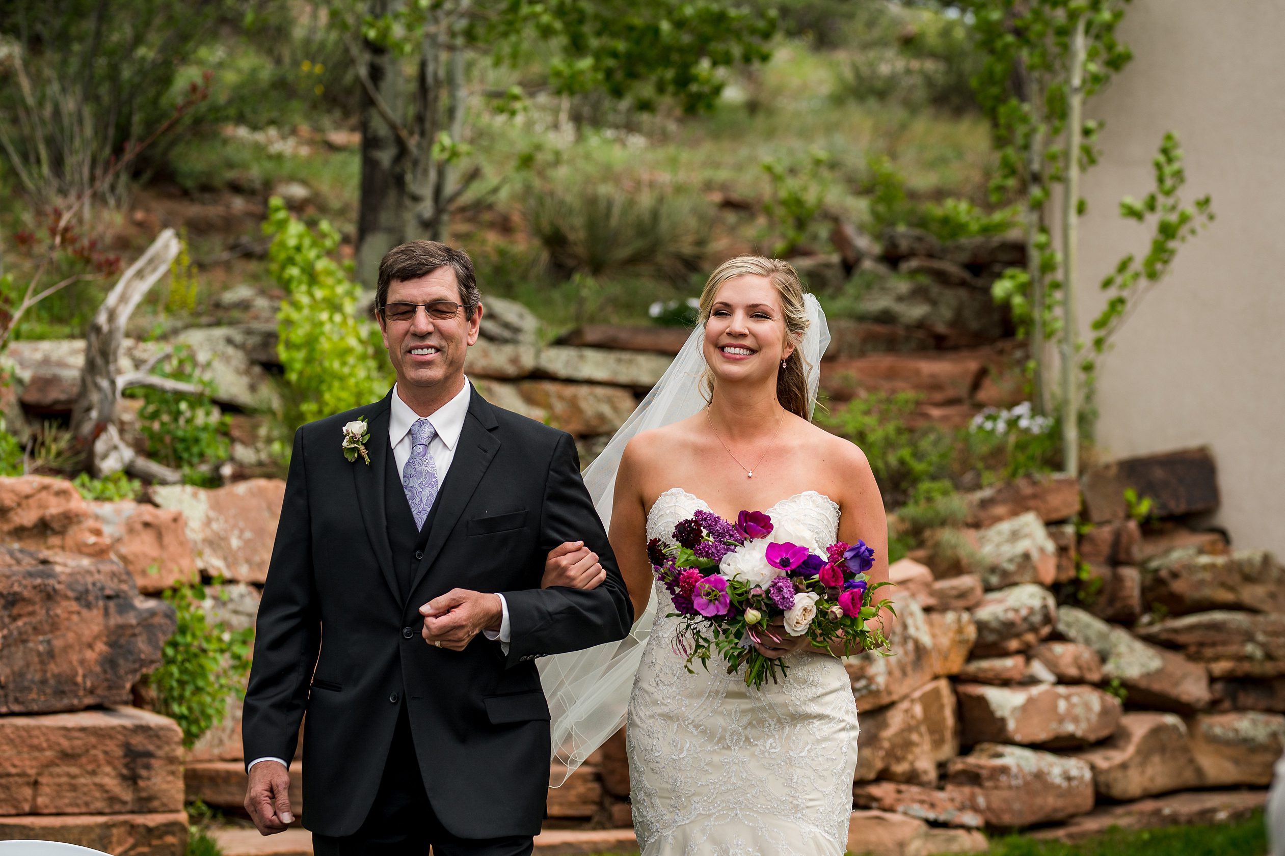 bride walking down the isle of her Colorado mountain wedding in Lyons, CO