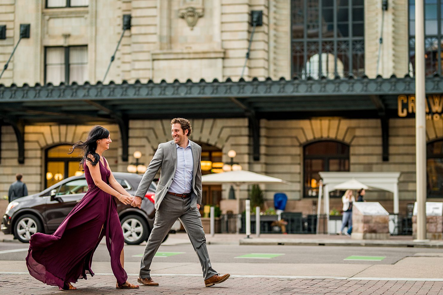 couple walking down the streets of Denver for their engagement photos