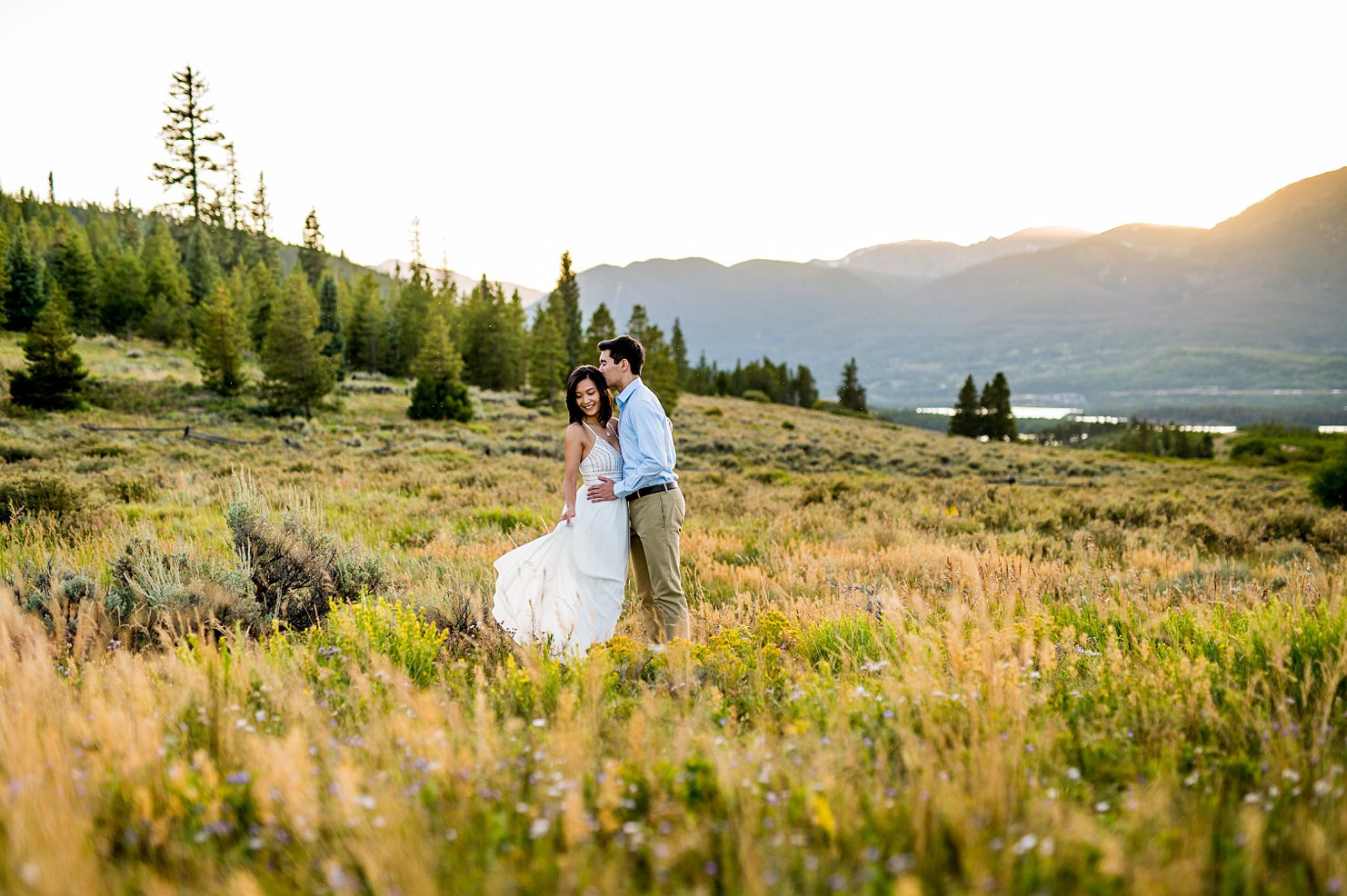engaged couple in a field in Breckenridge 