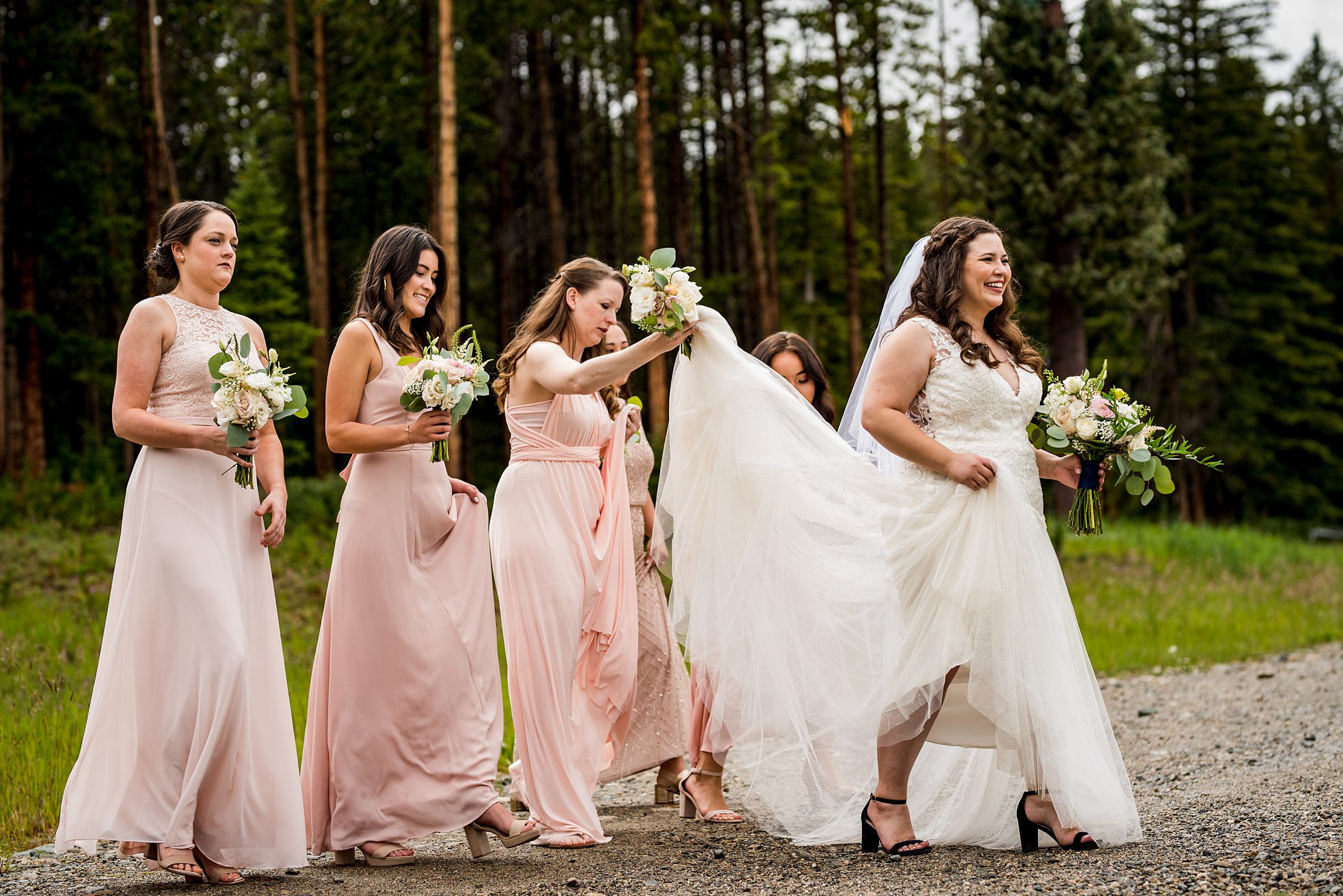 bridesmaids walking with the bride in Breckenridge