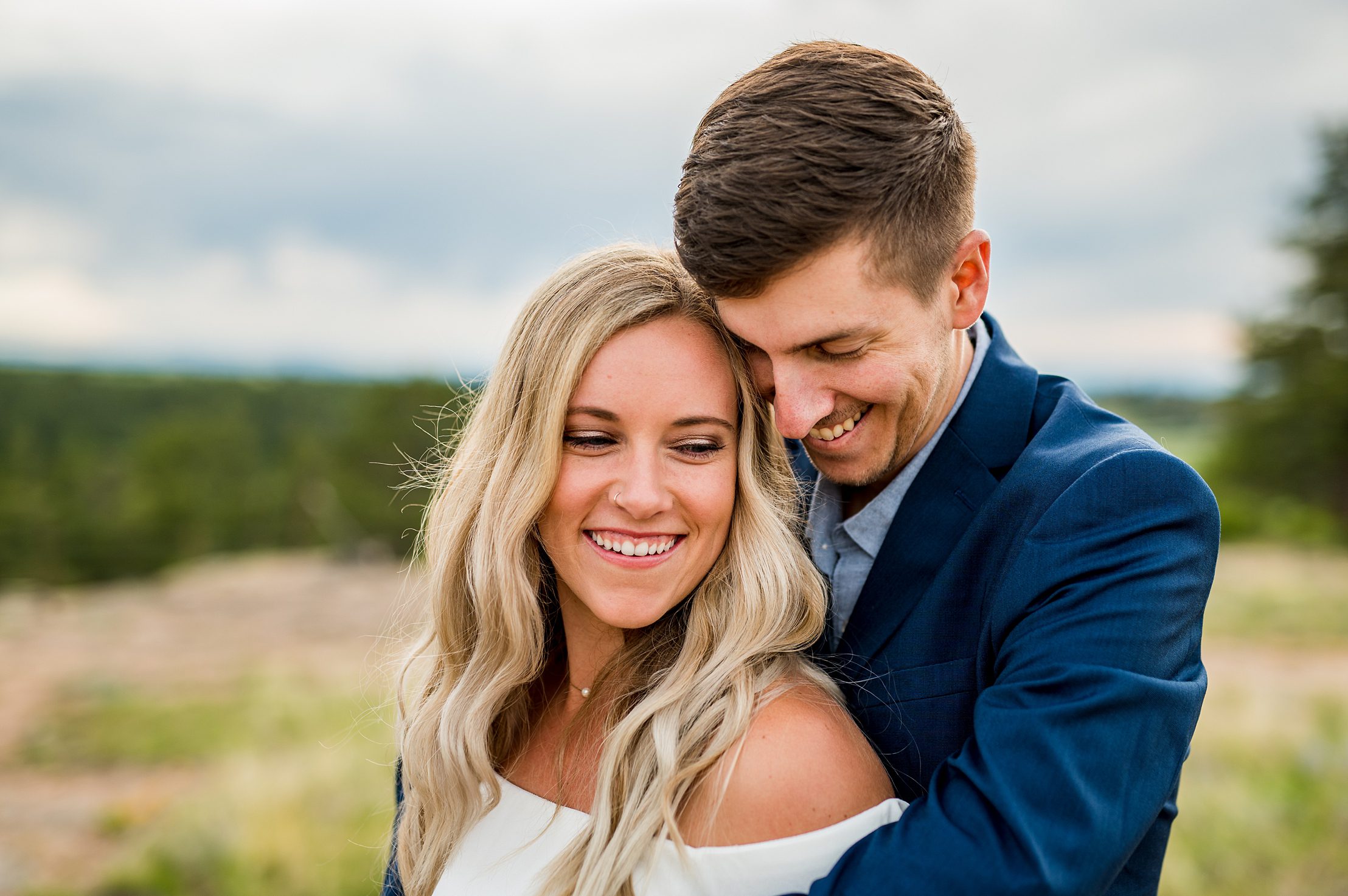 engaged couple struggling up to each other in Colorado