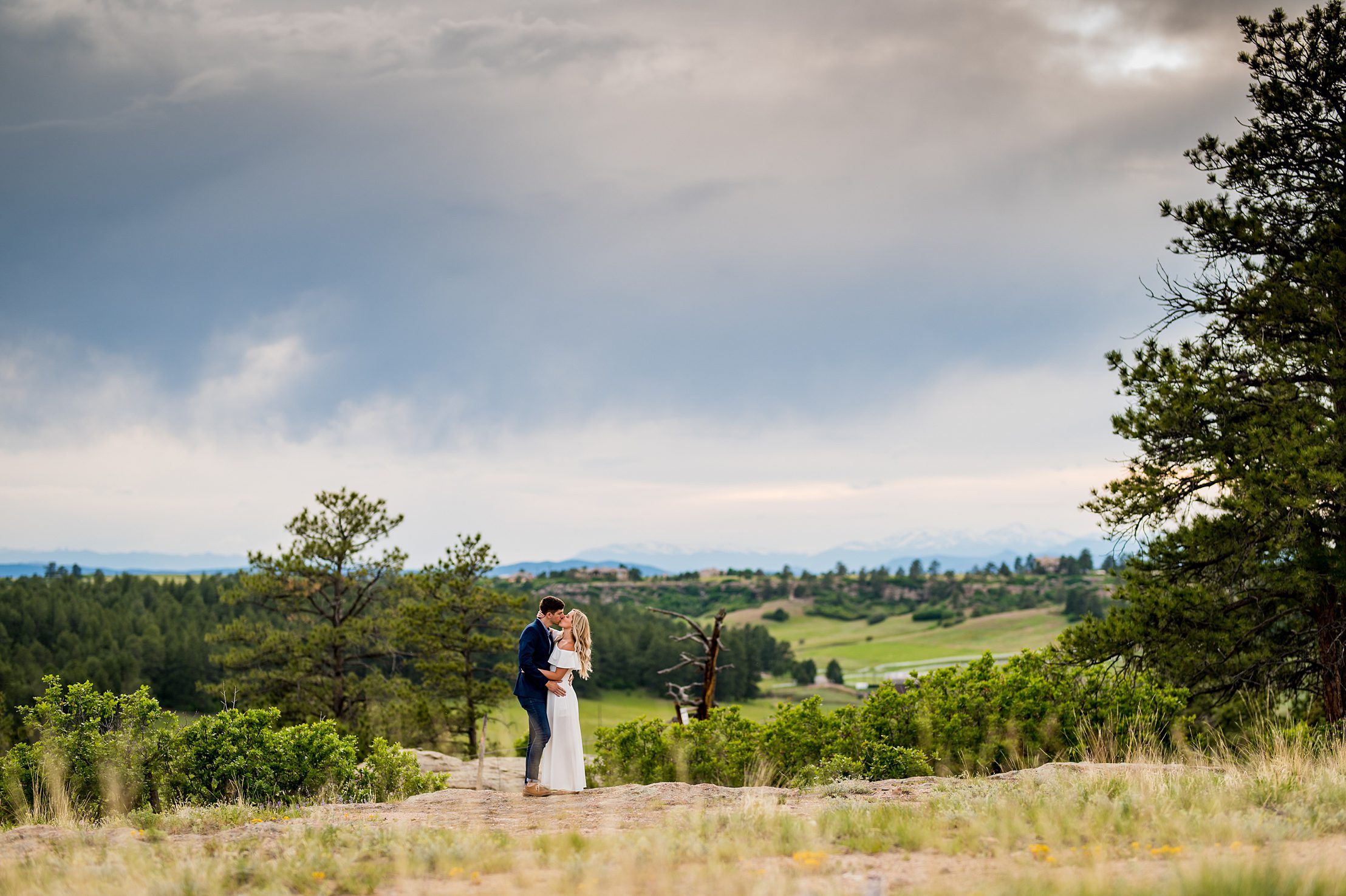 couple kissing with storm clouds in the background