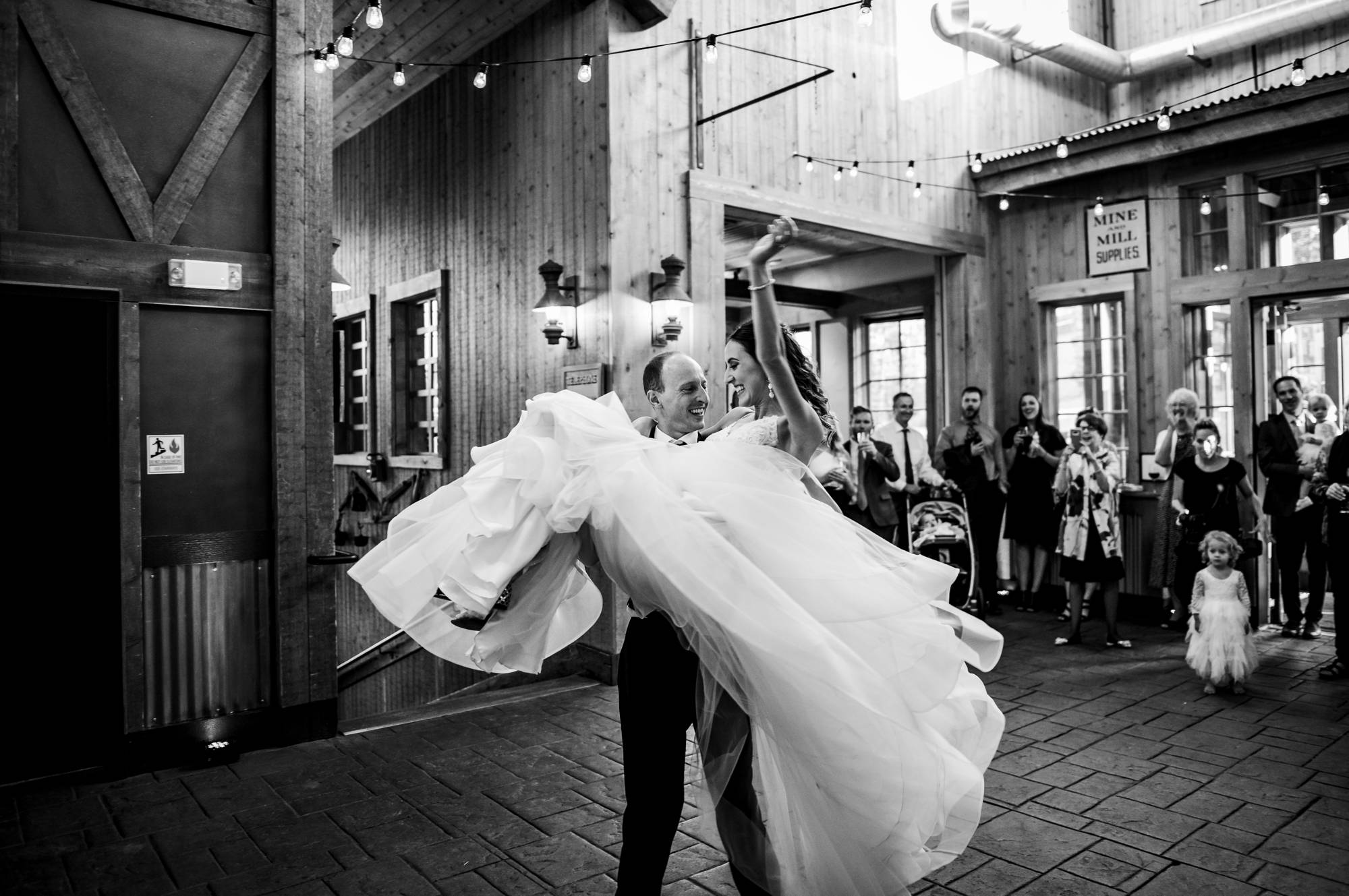 groom lifts his bride during their first dance
