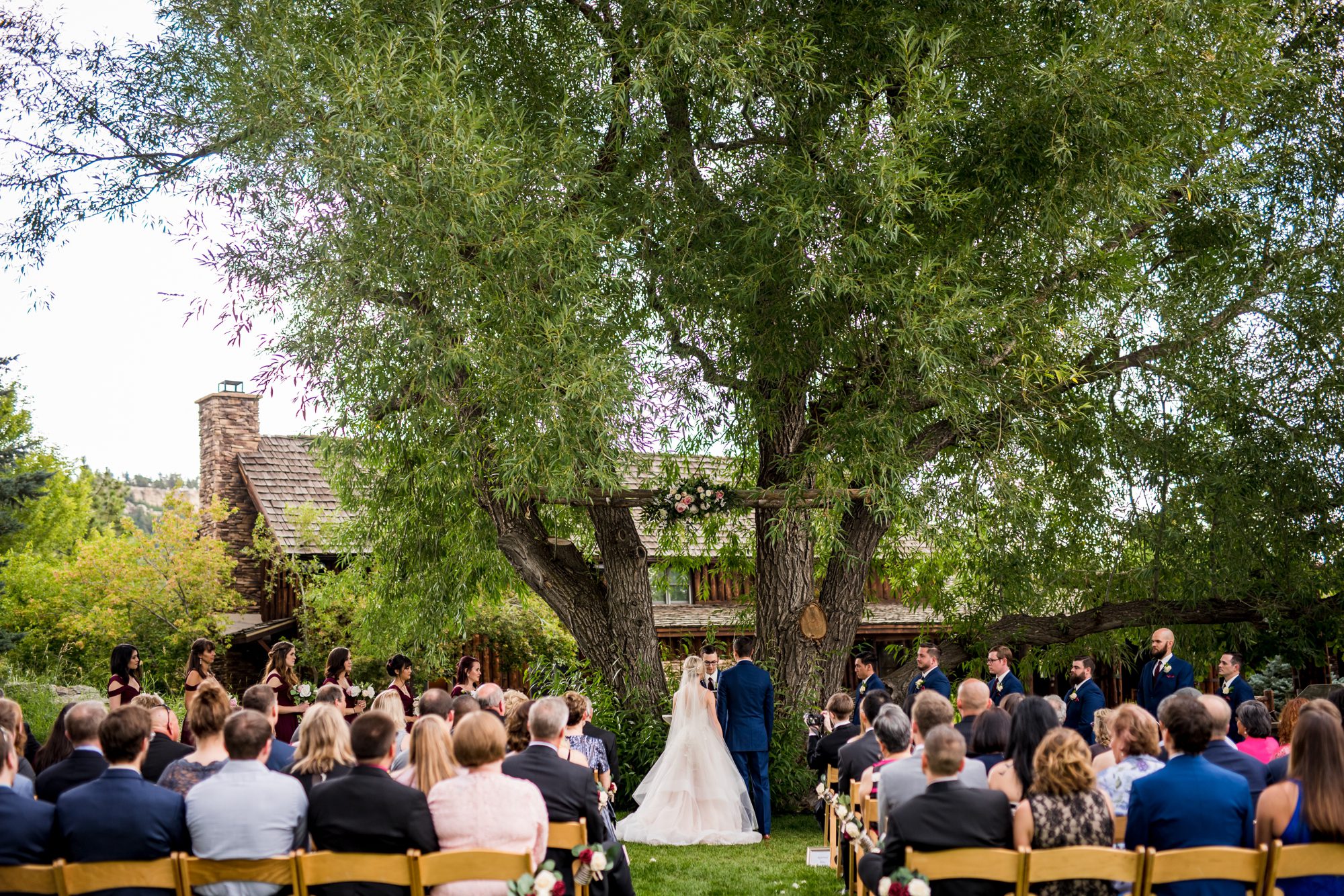 wedding ceremony under larger tree at Graces Chapel 