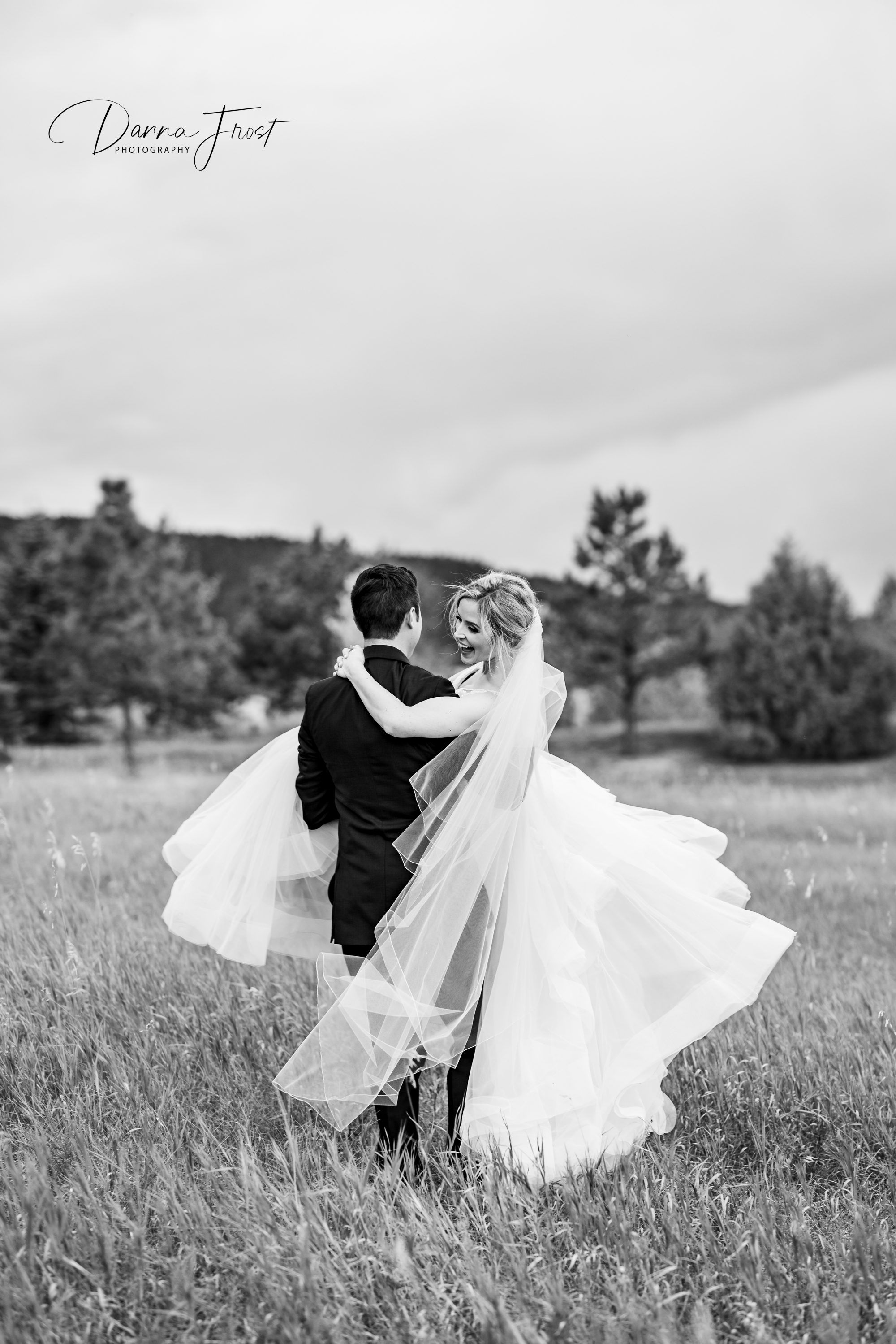 groom lifting his wife and spinning her