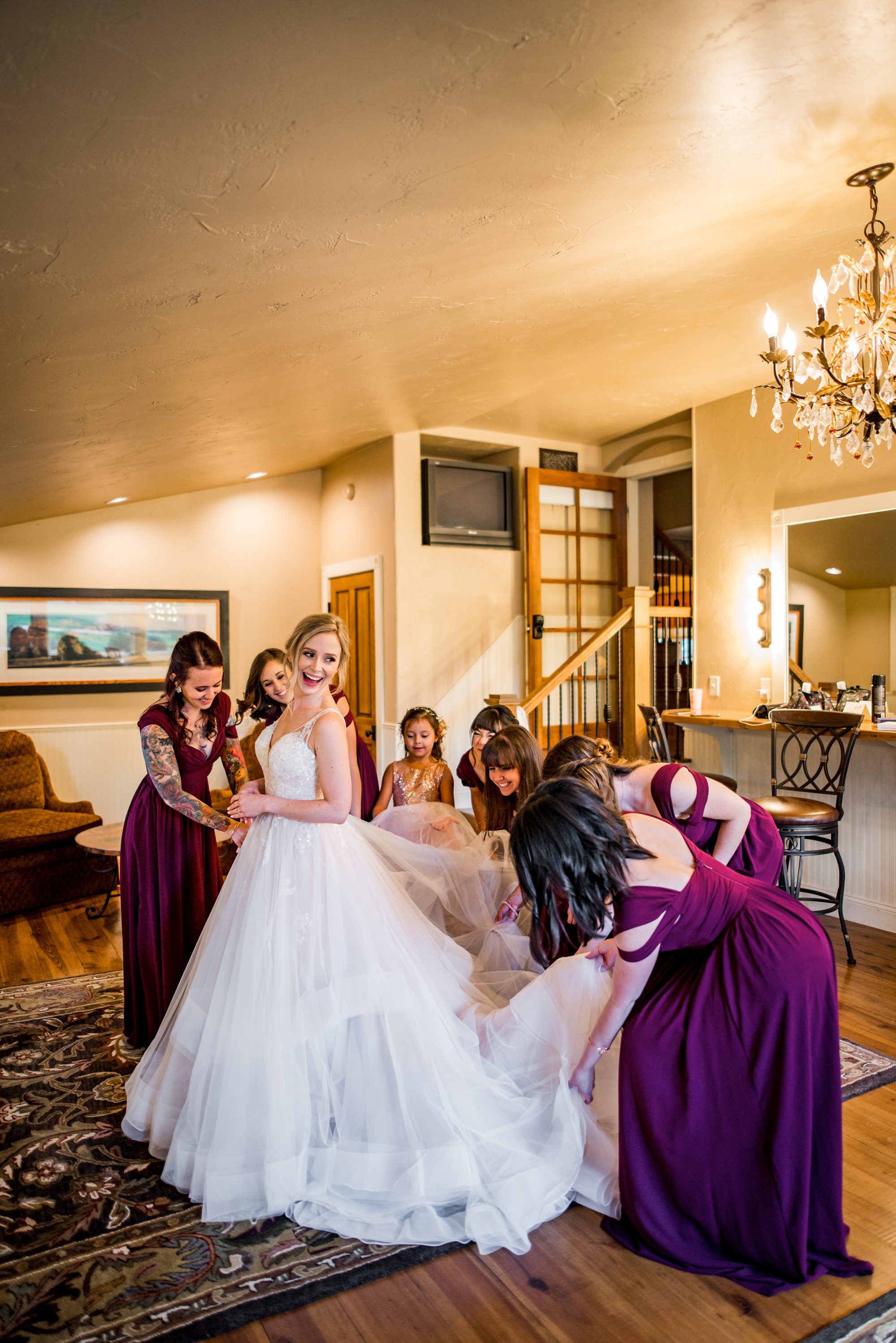 bridesmaids helping bride with her wedding dress in Colorado Springs