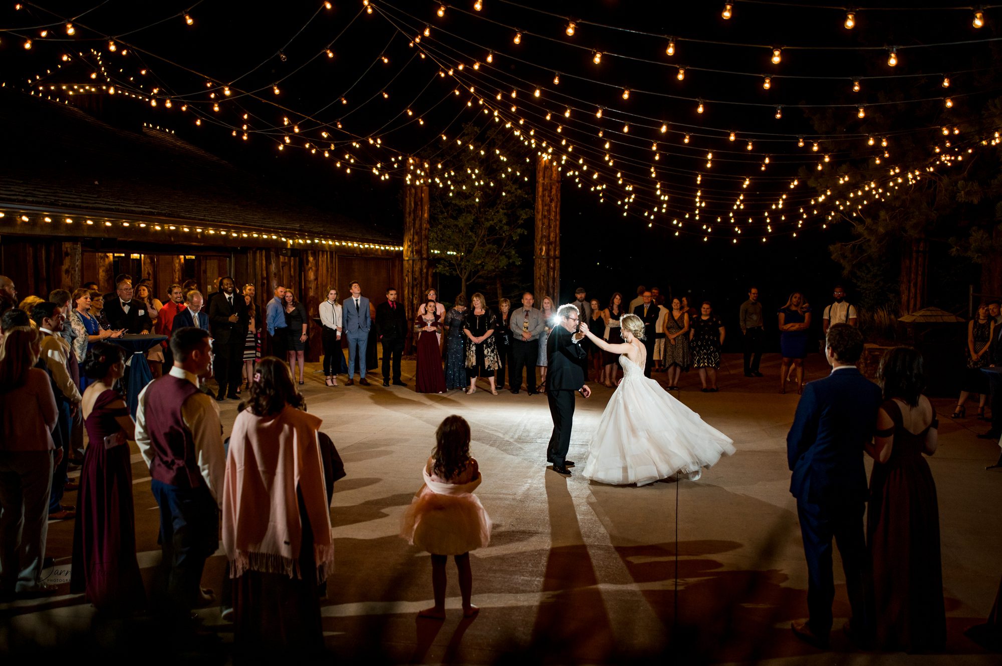 father spinning his daughter during the father/daughter dance at Spruce mountain ranch