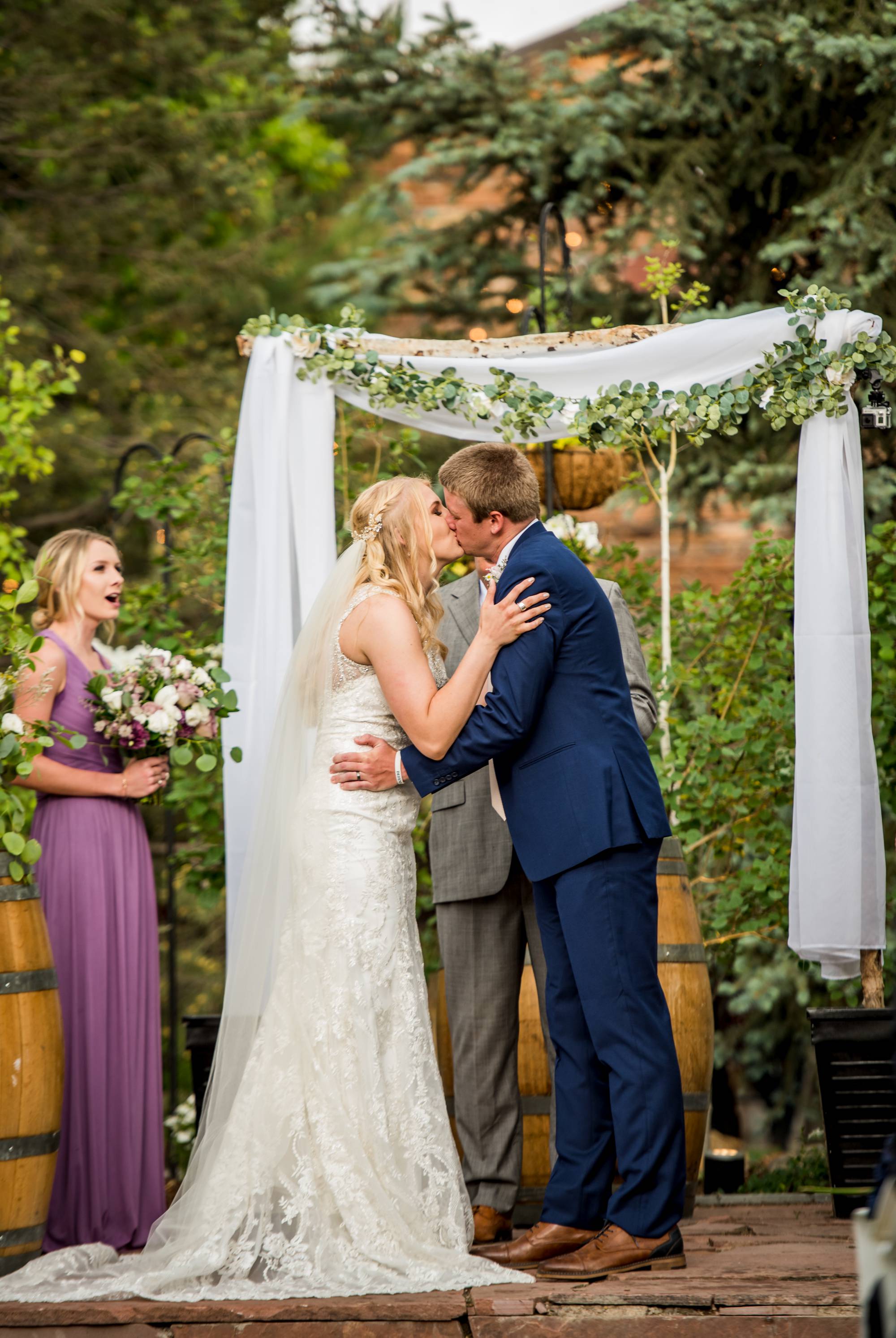 bride and groom have their first kiss after their wedding ceremony in Denver