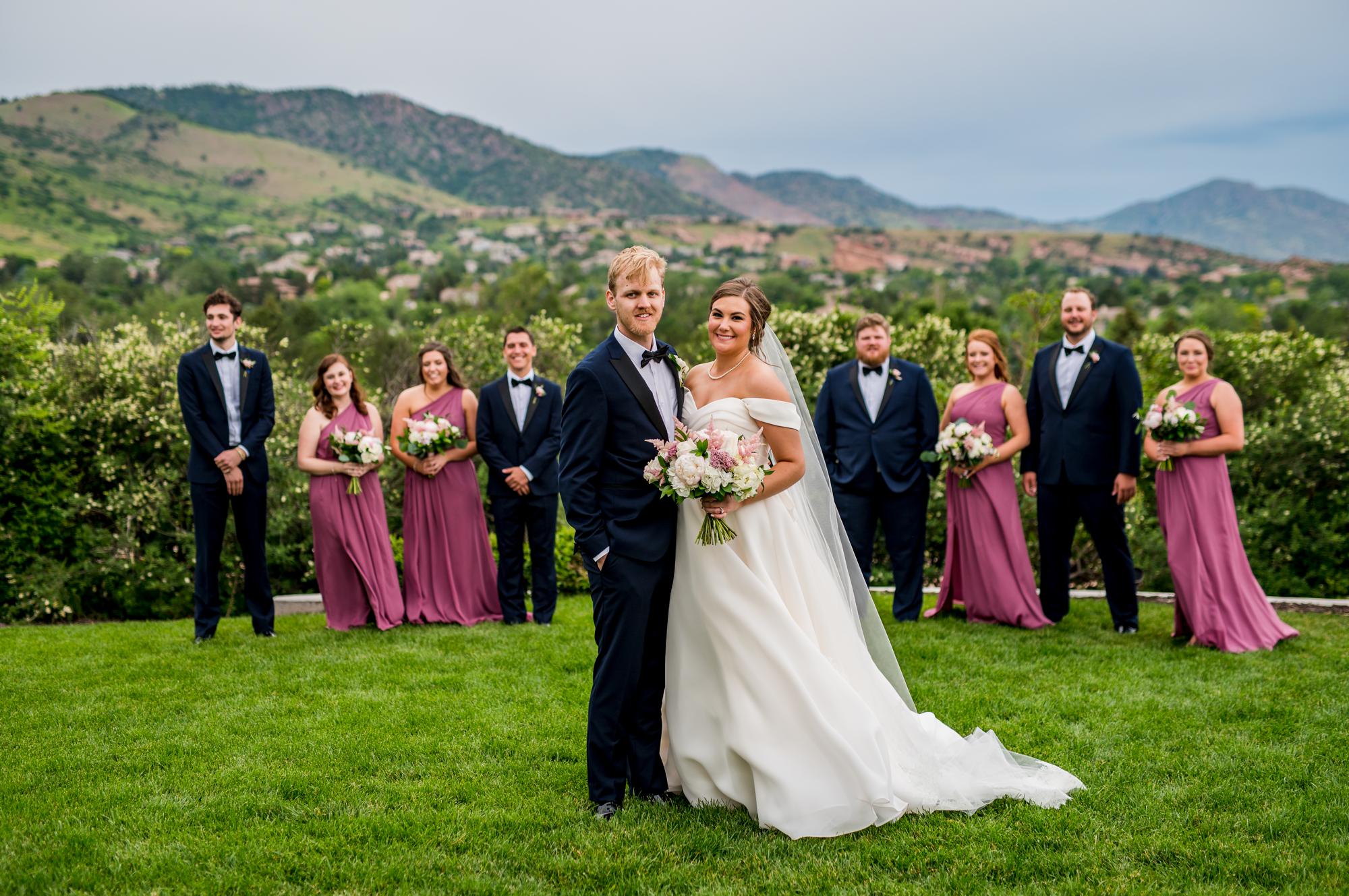 vibrant, colorful bridal party with the mountains in the background at The Manor House