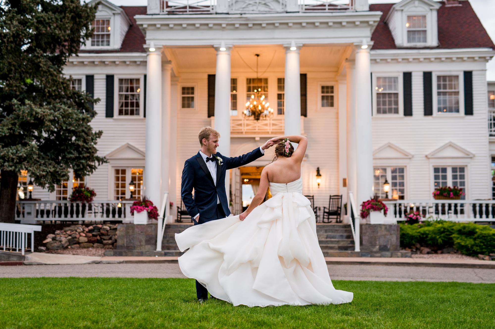 bride spinning his bride in front of The Manor House