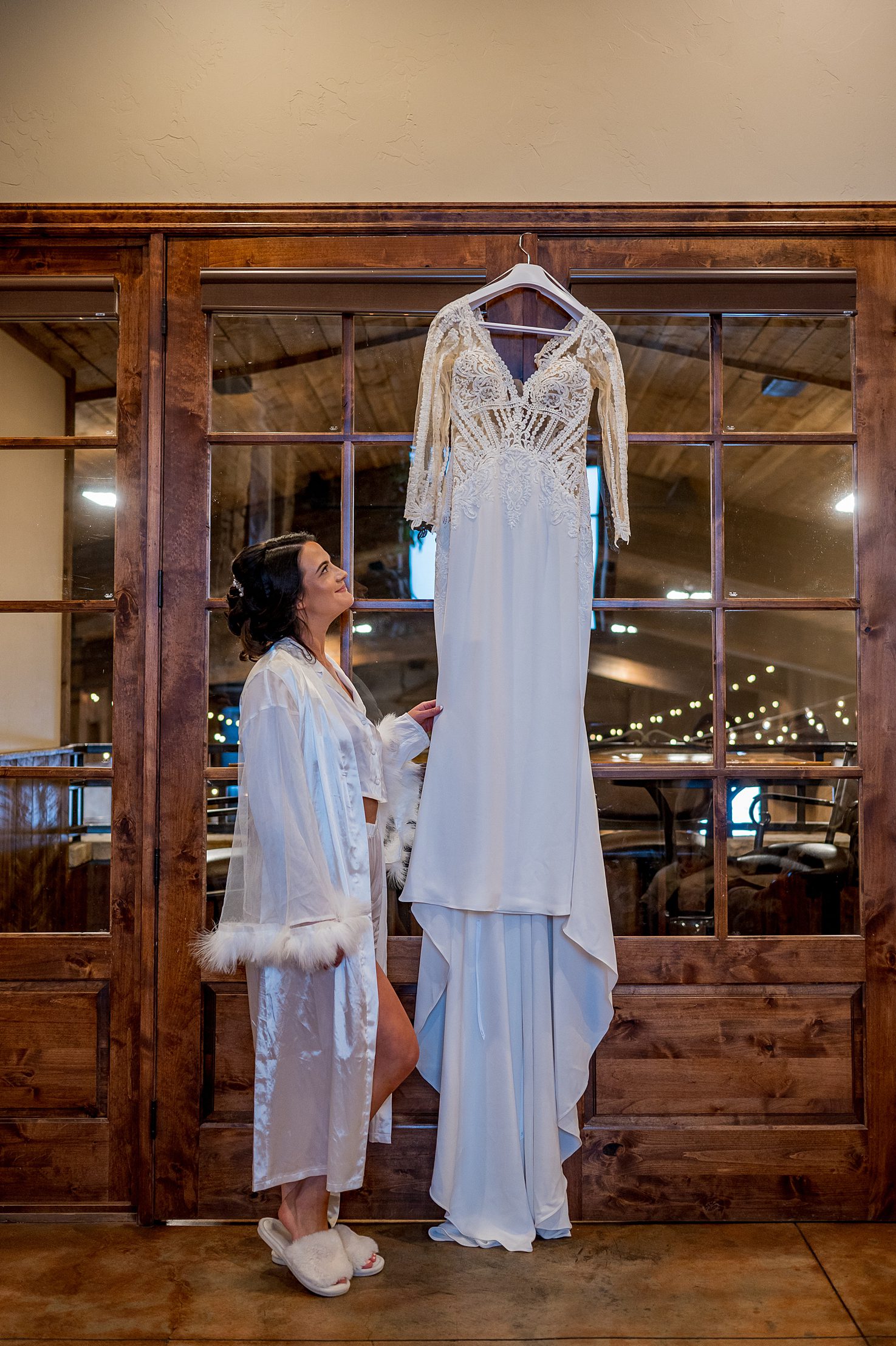 a bride looking at her wedding dress