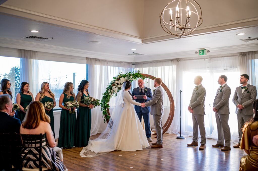 stunning wedding ceremony at Wedgwood Brittany Hill as the sun shines through the window.
