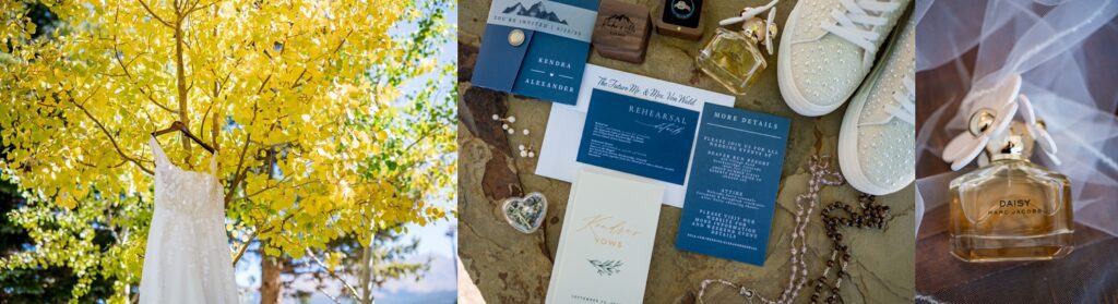 This is a stunning bridal gown lace floral gown flat lay set against a golden autumn tree along with navy blue wedding invitations with mountain themes, pearl embellished sneakers, sentimental jewelry, and a bottle of Daisy by Marc Jacobs perfume all set atop a veil background.