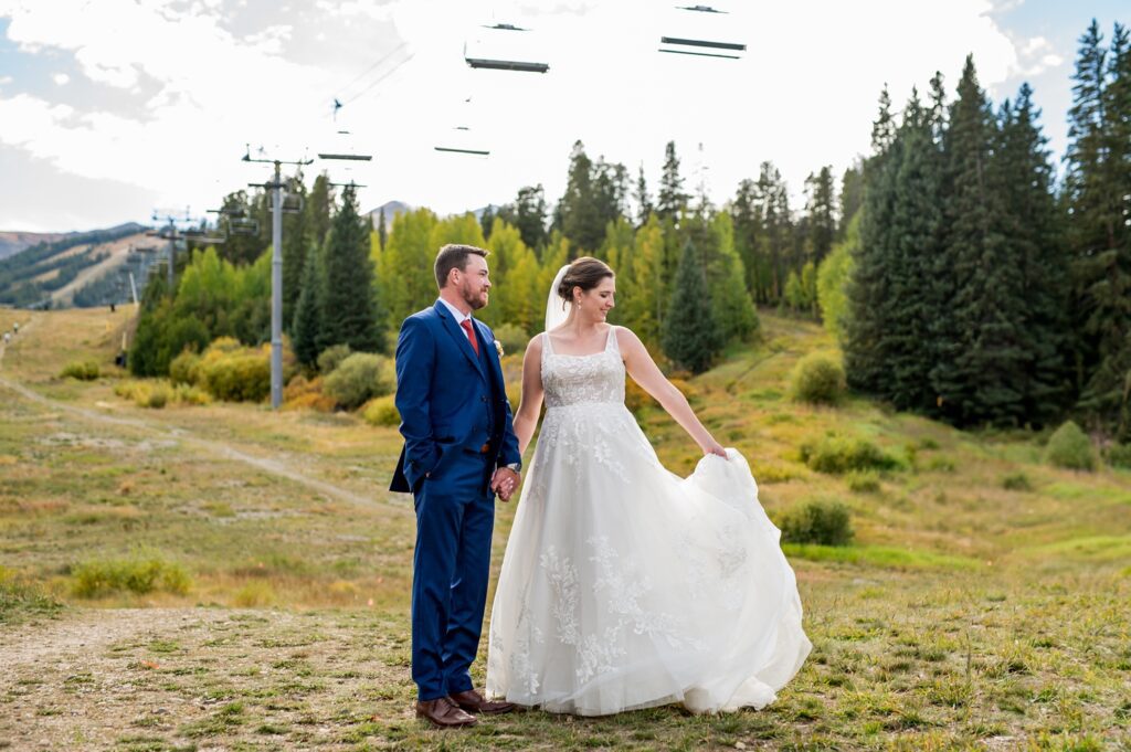 A beautiful bride in a dreamy dress made of lace is whirling around, while the handsome groom is looking at her being so proud of her. The professionalism of a well-experienced Colorado adventure and outdoor wedding photographer is unquestionable, as they always know how to create the wedding of your dreams.