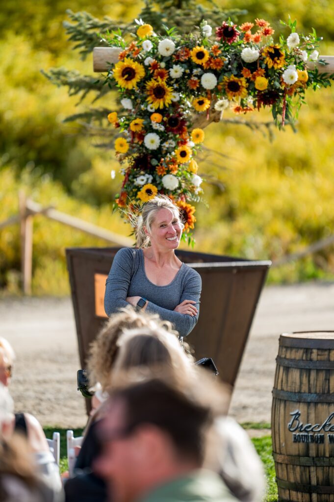 The Colorado wedding photographer is about to take pictures of a nice outdoorsy wedding ceremony near the Breckenridge Beaver Run Resort. A natural wood arch is elegantly decorated with radiant sunflower and autumn flowers. This mixture of elements will surely captivate the guests and create unforgettable memories.