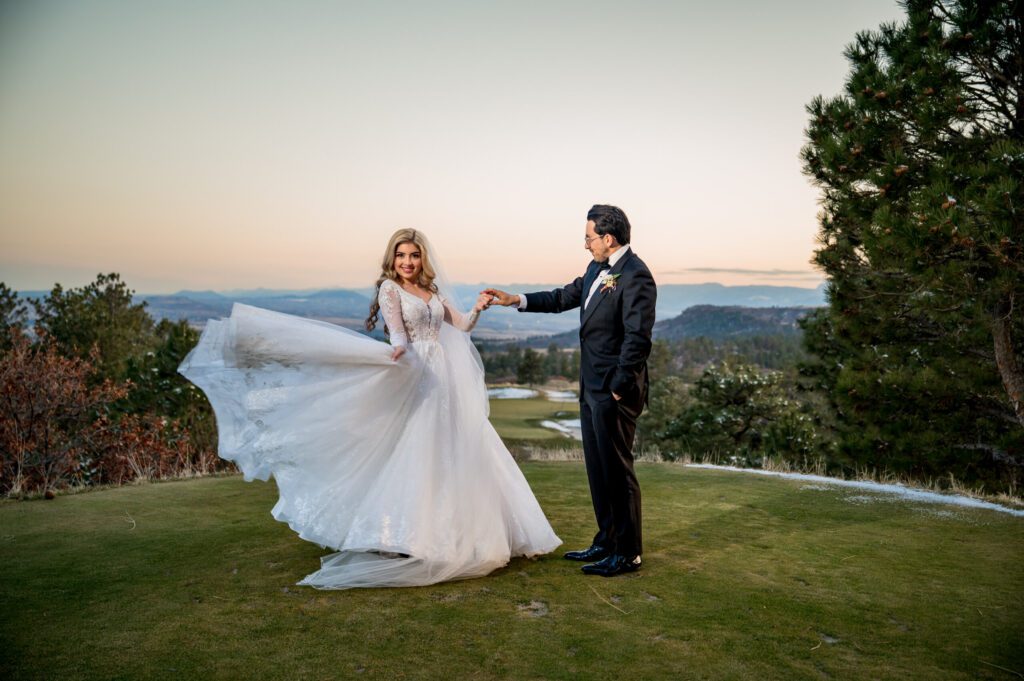 wedding couple dancing after they got married in Denver. They are doing their wedding photos at sanctuary golf course in Castle Rock, CO