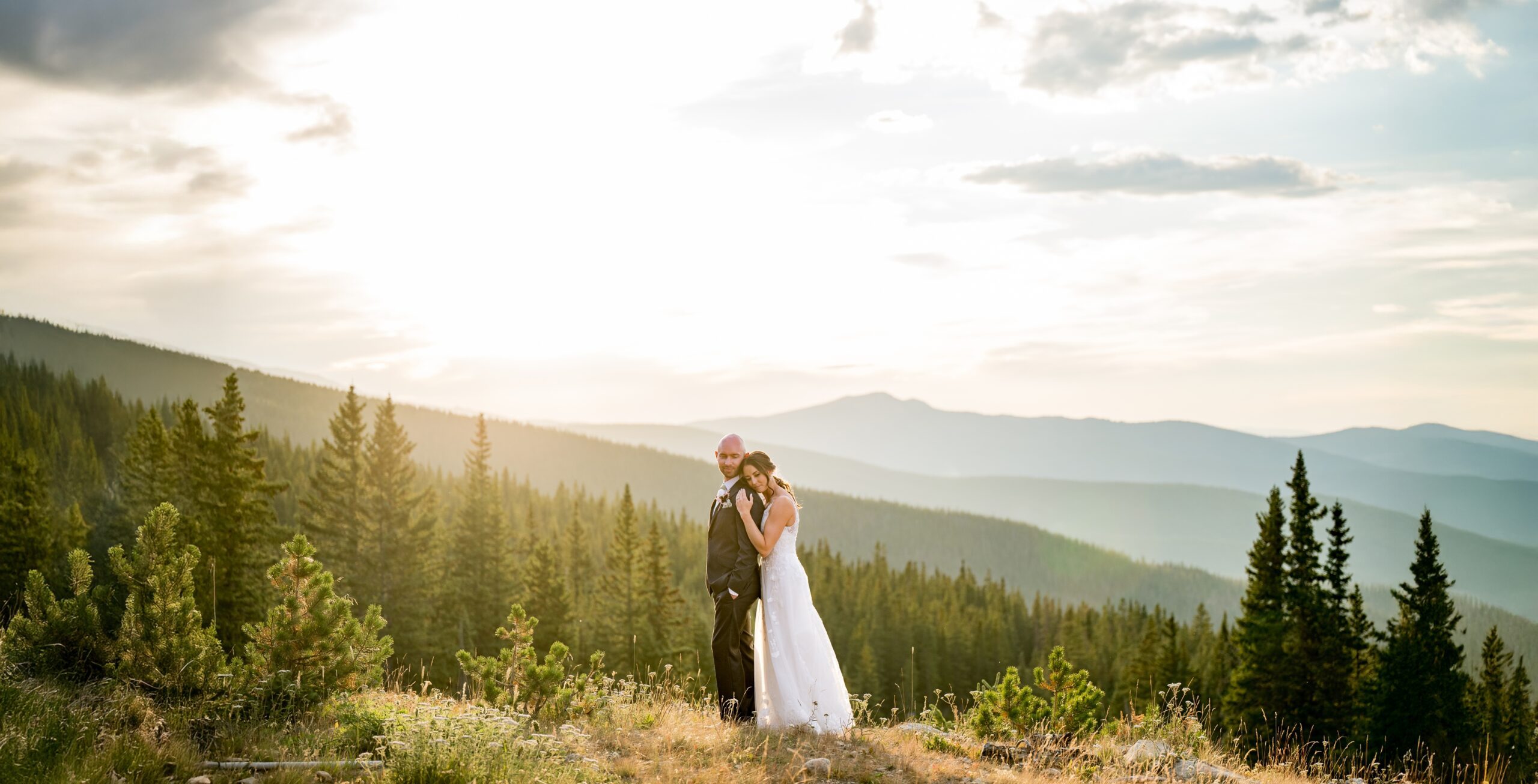 wedding couple standing at the top of the mountain at Lunch Rock in Winter Park.