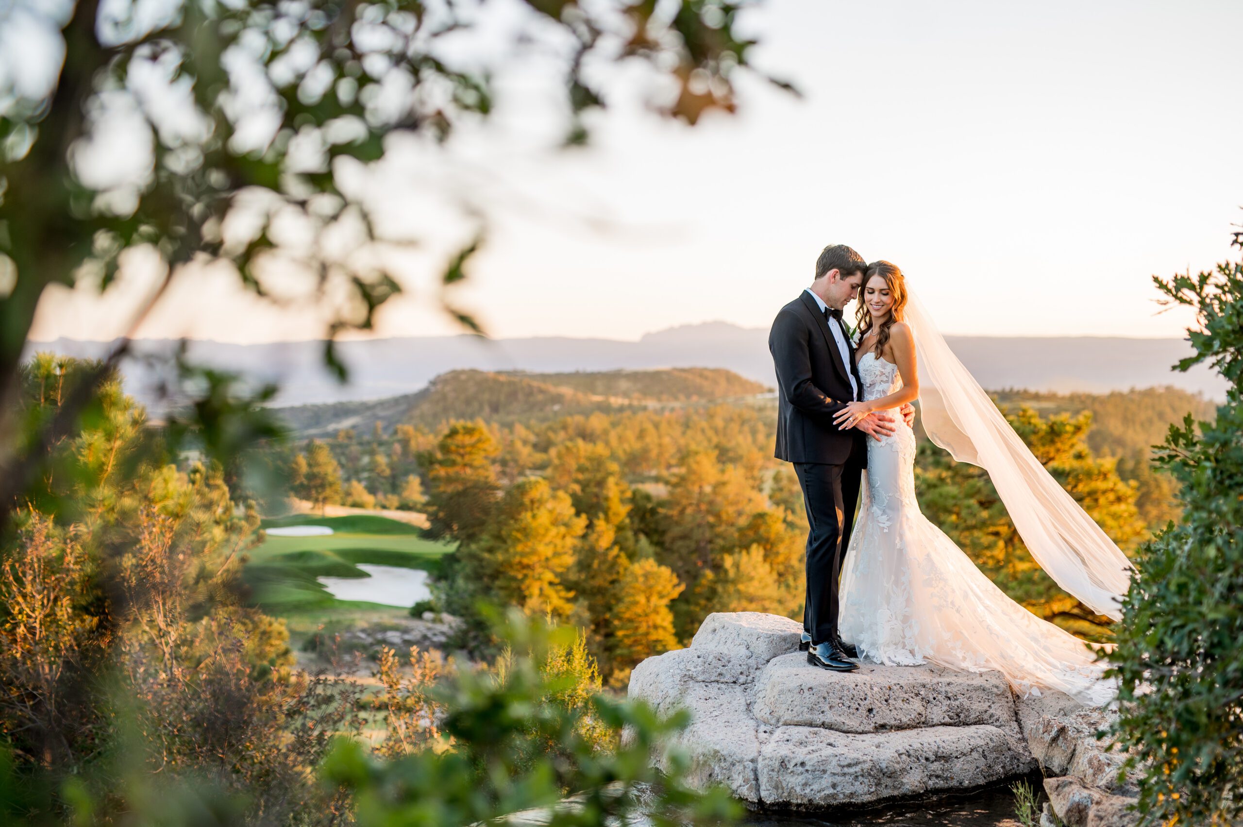 Stunning wedding couple with bride showing off her wedding dress during sunset at The Sanctuary Golf Course.